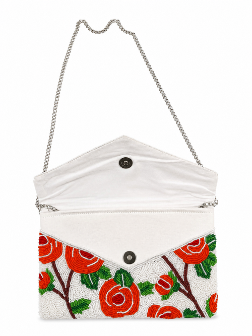White clutch with red floral design on a white background