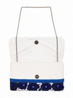 White handbag with blue floral pattern and chain strap on a white background