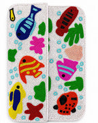 Colorful beaded handmade bag with fish and sea-themed designs on a white background