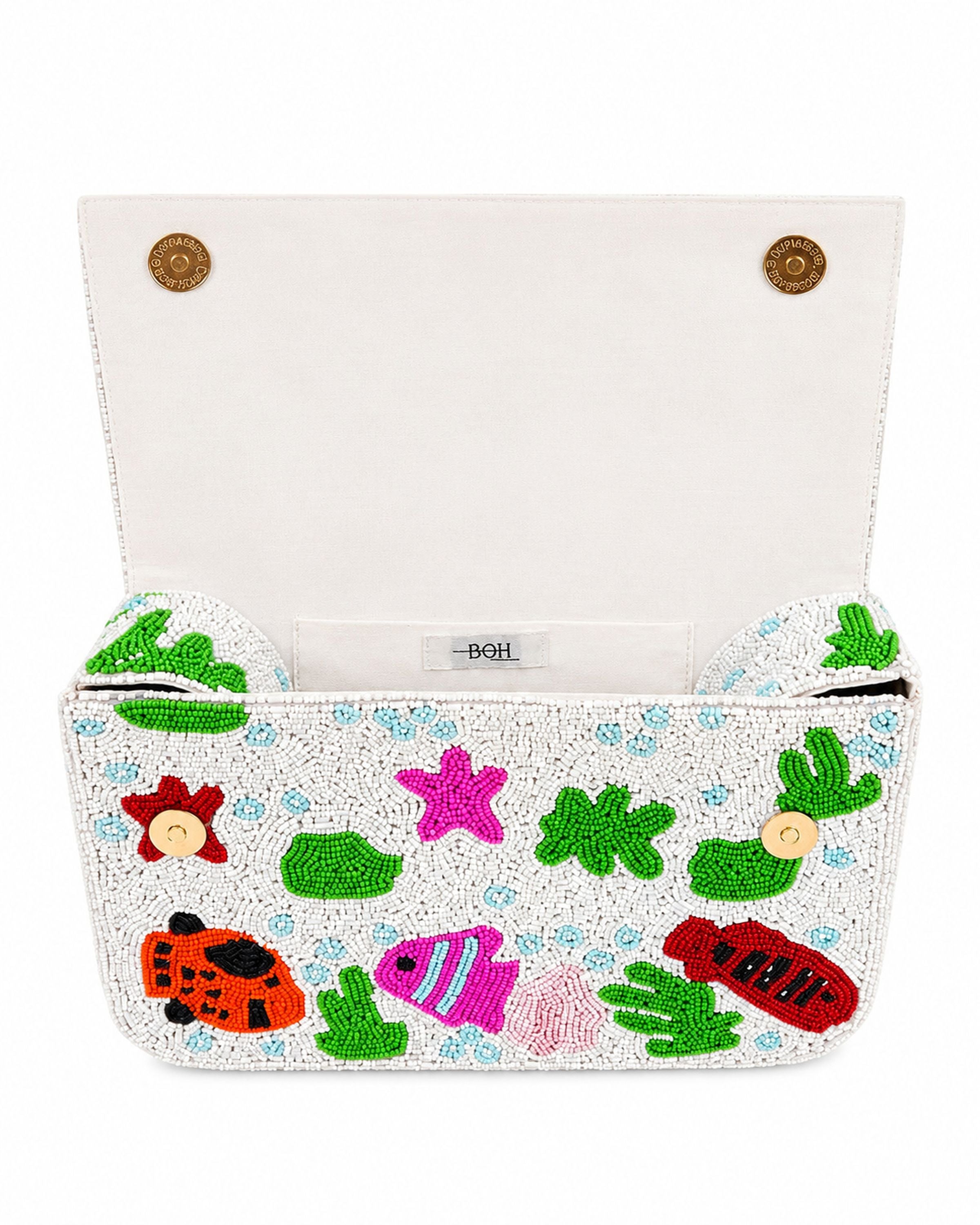 Colorful beaded handmade bag with fish and sea-themed designs on a white background